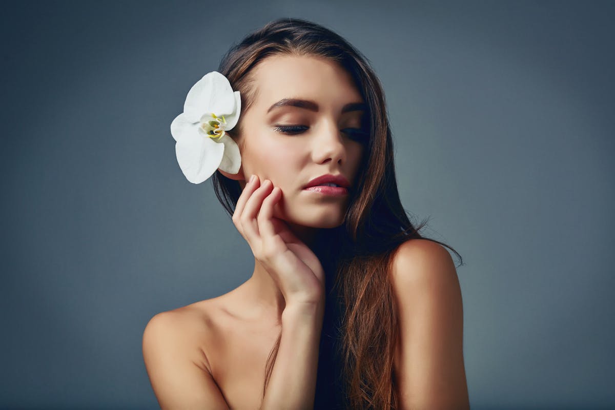 Beautiful Girl with a flower on her hair