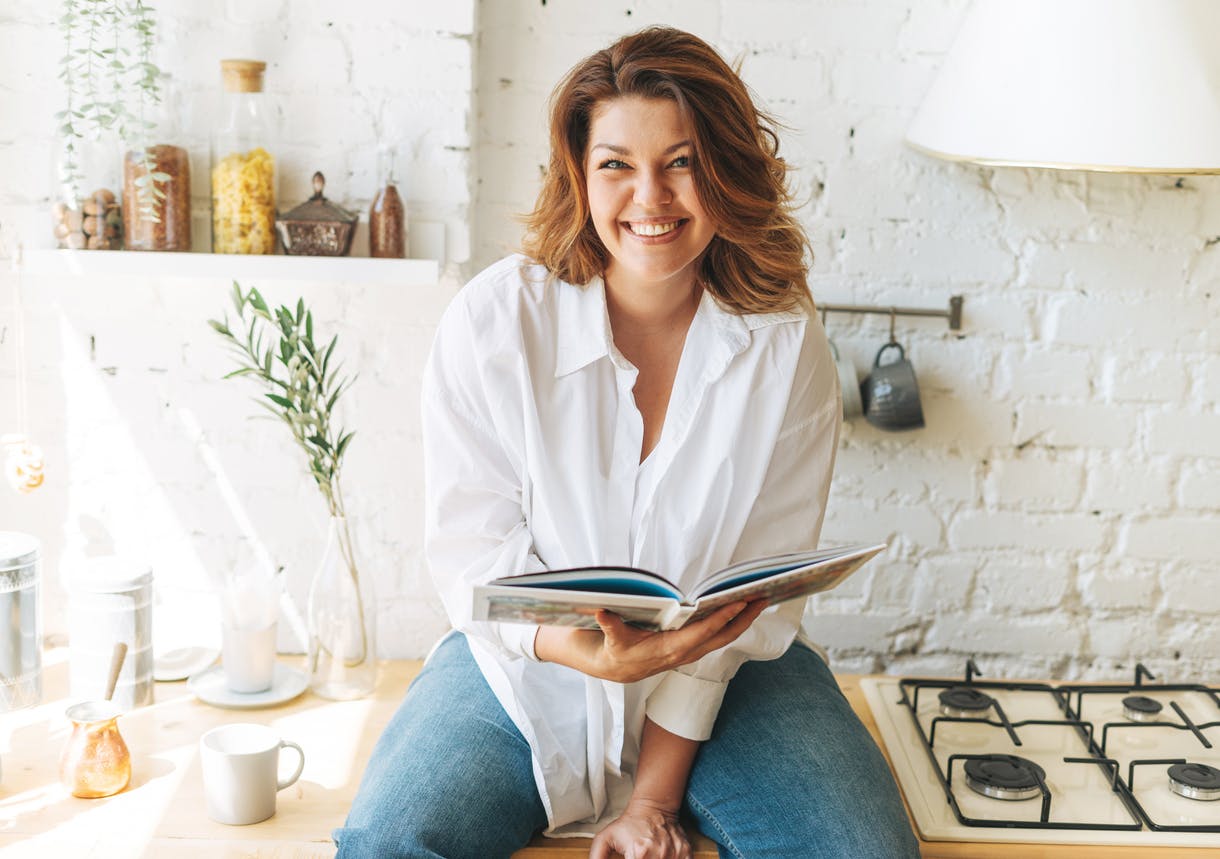 Woman in white t shirt and reading a book