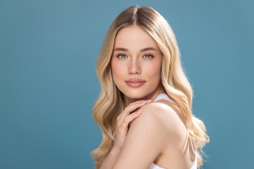 Beautiful Woman with clear fresh skin looking at the Camera