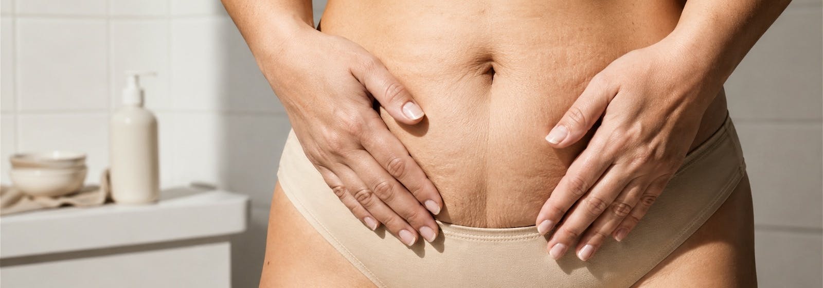 postpartum woman with hands placed on her stomach