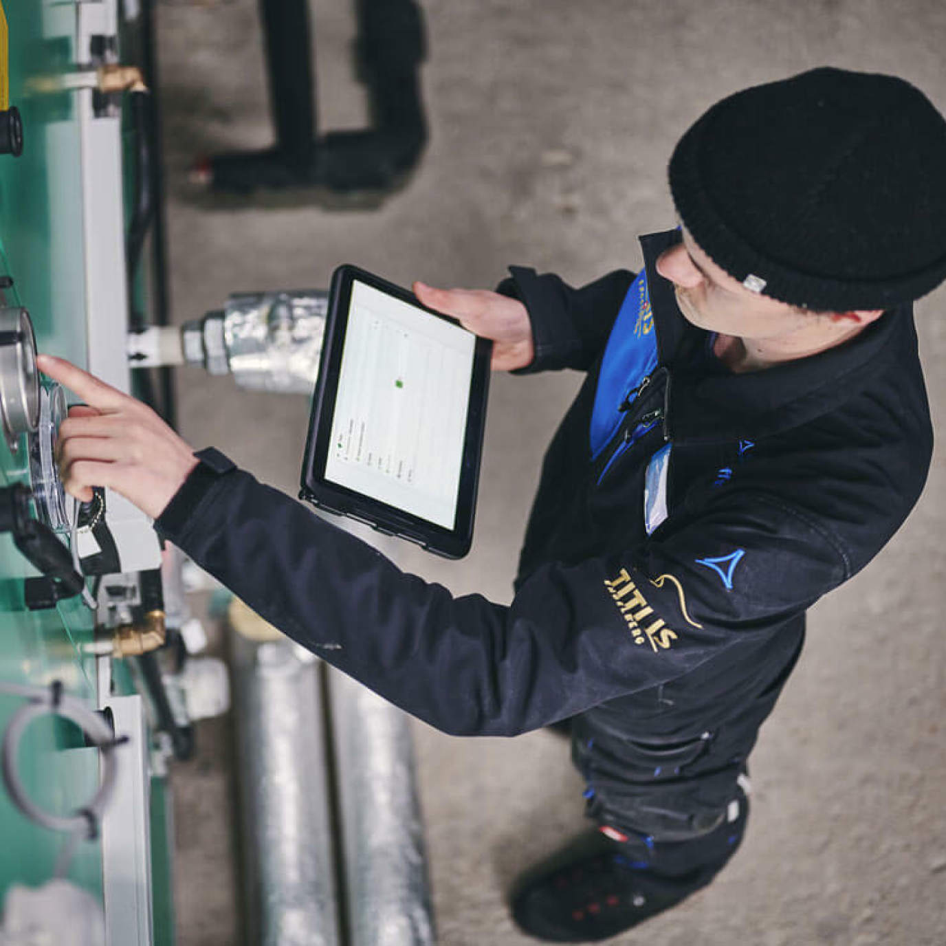 A resort employee performing maintenance on a facility, with the clair App open on a tablet in hand.