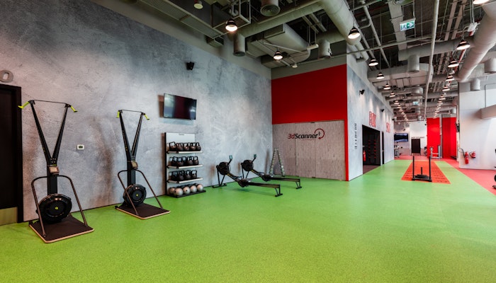 Fitness First Functional training zone featuring fitness equipment against a vibrant green and red floor