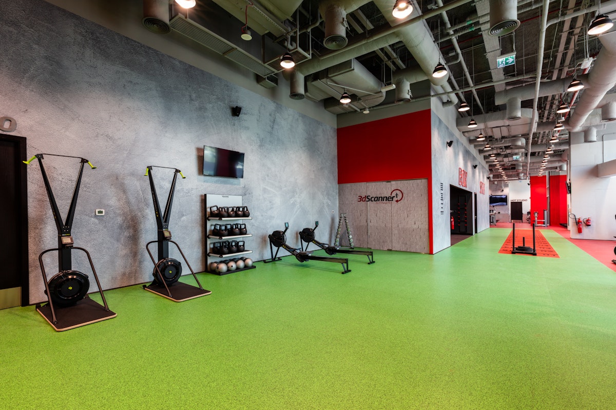 Fitness First Functional training zone featuring fitness equipment against a vibrant green and red floor