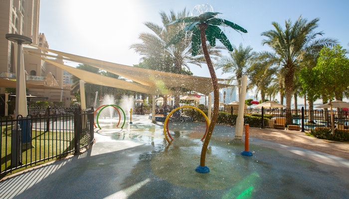 Fairmont The Palm Water playground with colorful water jets and palm tree-shaped sprayers.