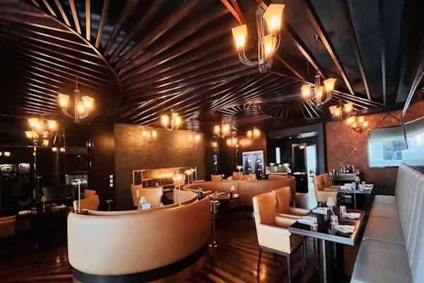 Elegant interior with cozy booths and warm lighting.