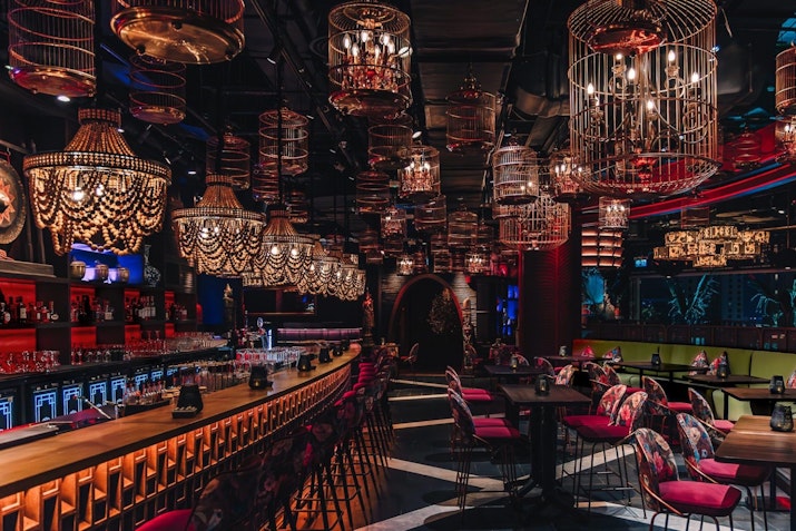 Opulent chandeliers, ornate decor, and a sophisticated dining atmosphere.