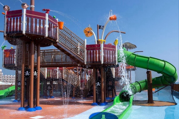 Pirate-themed water play area with slides, water sprays, and colorful features.