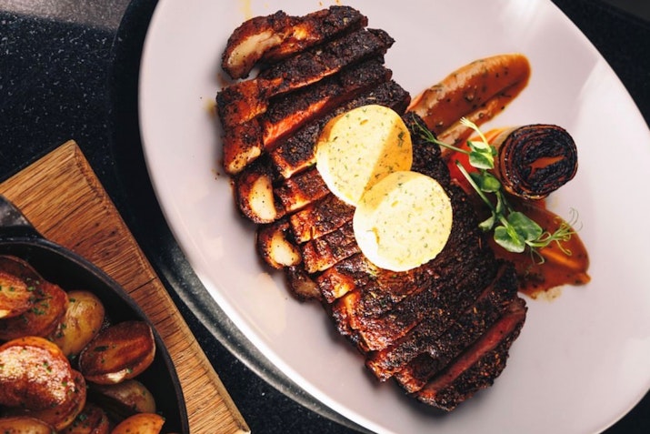 Luxurious interior, known for its award-winning steaks and stylish ambiance.
