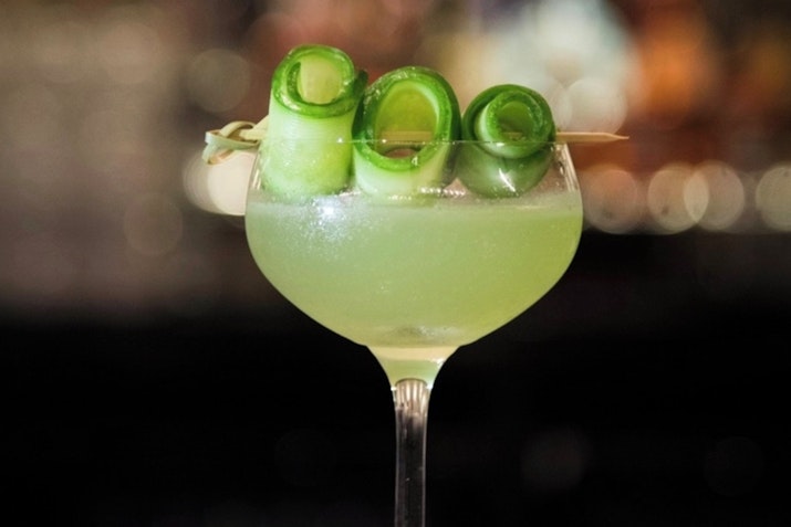 A selection of beautifully crafted cocktails, each with distinctive garnishes and vibrant colors.