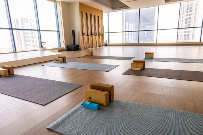 Peaceful yoga space featuring wooden floors, yoga mats and yoga blocks
