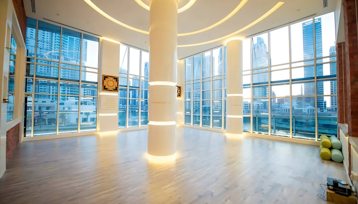 Trident Wellness Centre Large floor-to-ceiling windows, wooden floors and unique lighting.