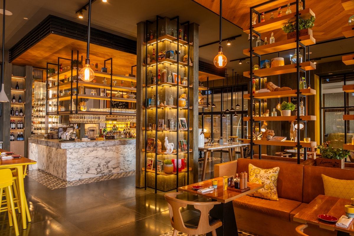 Discover Verso at Grand Hyatt Abu Dhabi: a chic dining space with a warm, inviting ambiance. Discover Verso at Grand Hyatt Abu Dhabi: stylish interior with cozy seating and elegant decor.