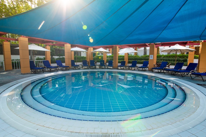 Sheraton Jumeirah Beach Resort Shaded circular pool with surrounding lounge chairs.