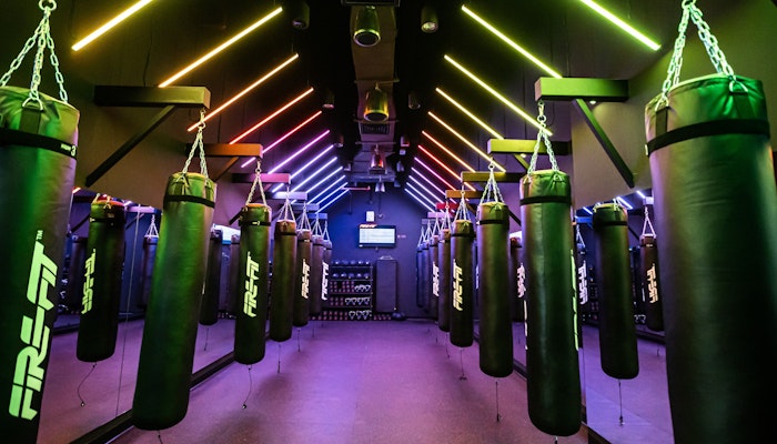 FIRE Fit High-energy gym space with advanced equipment and vibrant lighting for dynamic workouts.