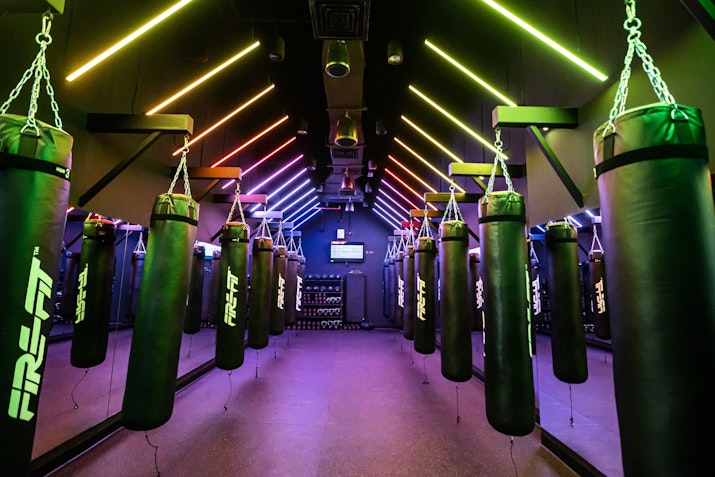 High-energy gym space with advanced equipment and vibrant lighting for dynamic workouts.