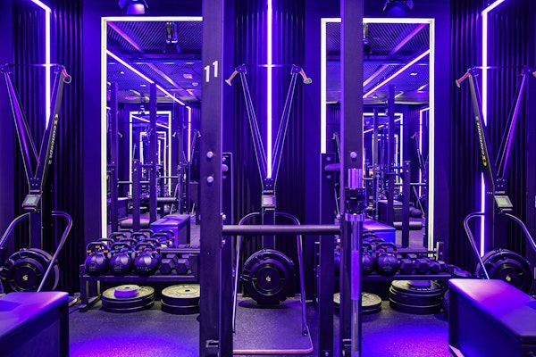 Fitness space with neon lighting and functional fitness equipment