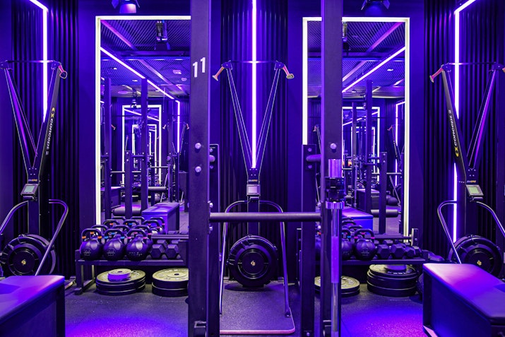 Fitness space with neon lighting and functional fitness equipment