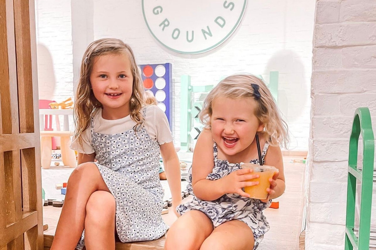 Enjoy kid-friendly dining at Common Grounds: two happy children in a playful, family-friendly setting.