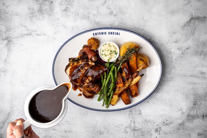 Plate of roast meat, vegetables, and gravy