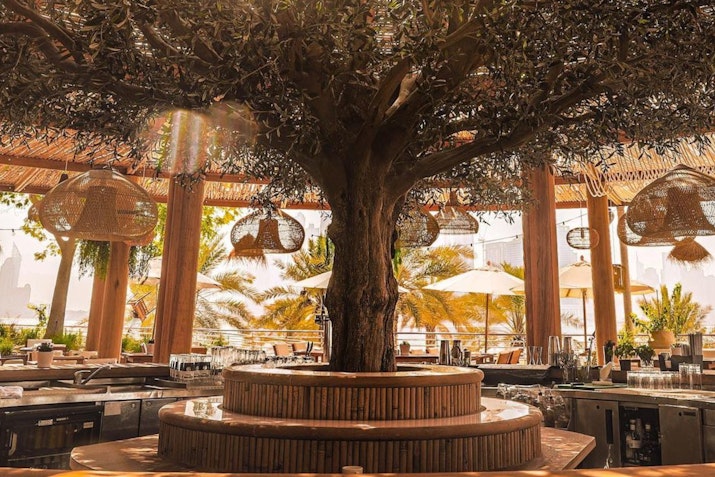 Vibrant beachfront restaurant offering Mediterranean cuisine with a lively atmosphere and stunning sea views