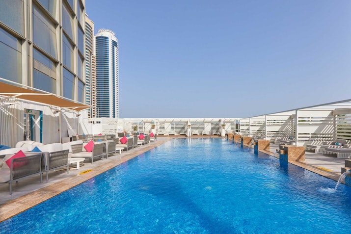 Rooftop pool with lounge seating and city view