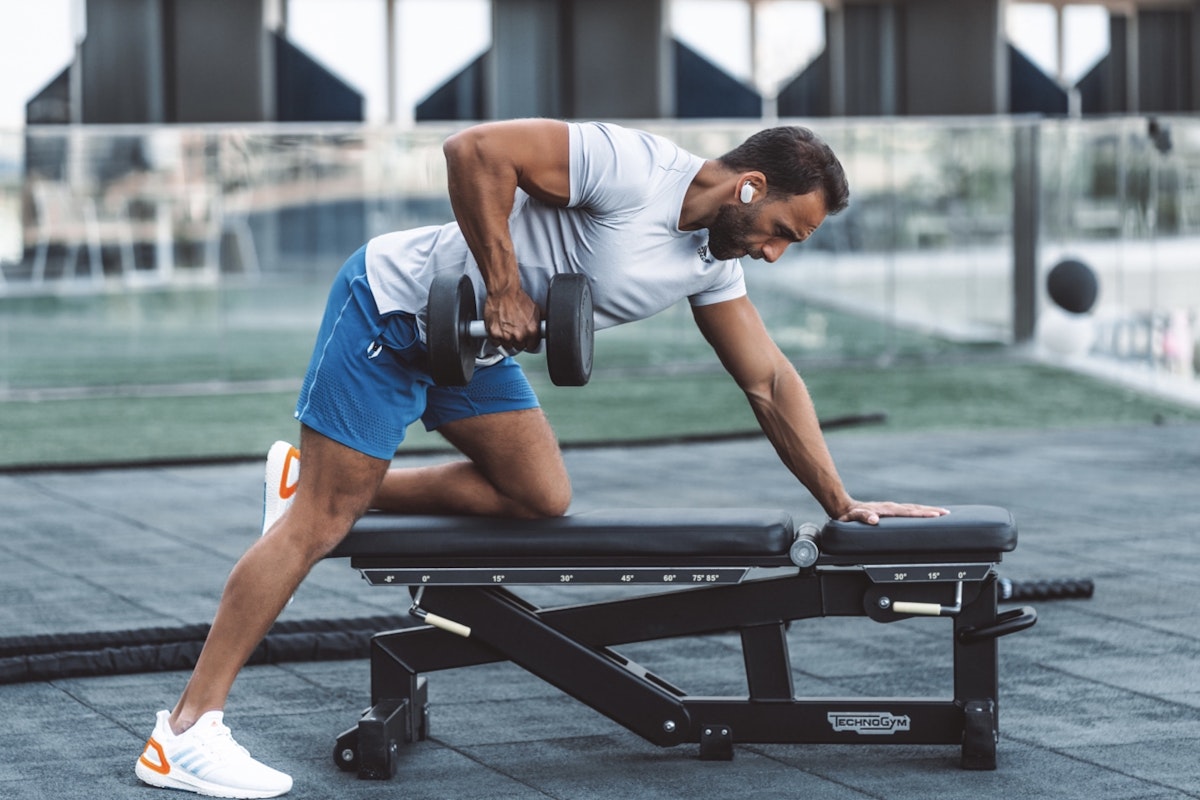 Fitness expert, Rabih El Turk, shares his favourite Privilee gyms Man doing a workout with a dumbbell on a bench at a gym.