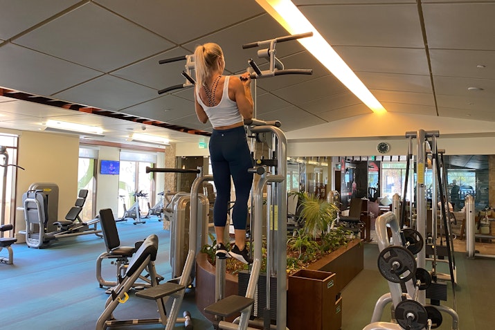 Person performing pull-ups on gym equipment