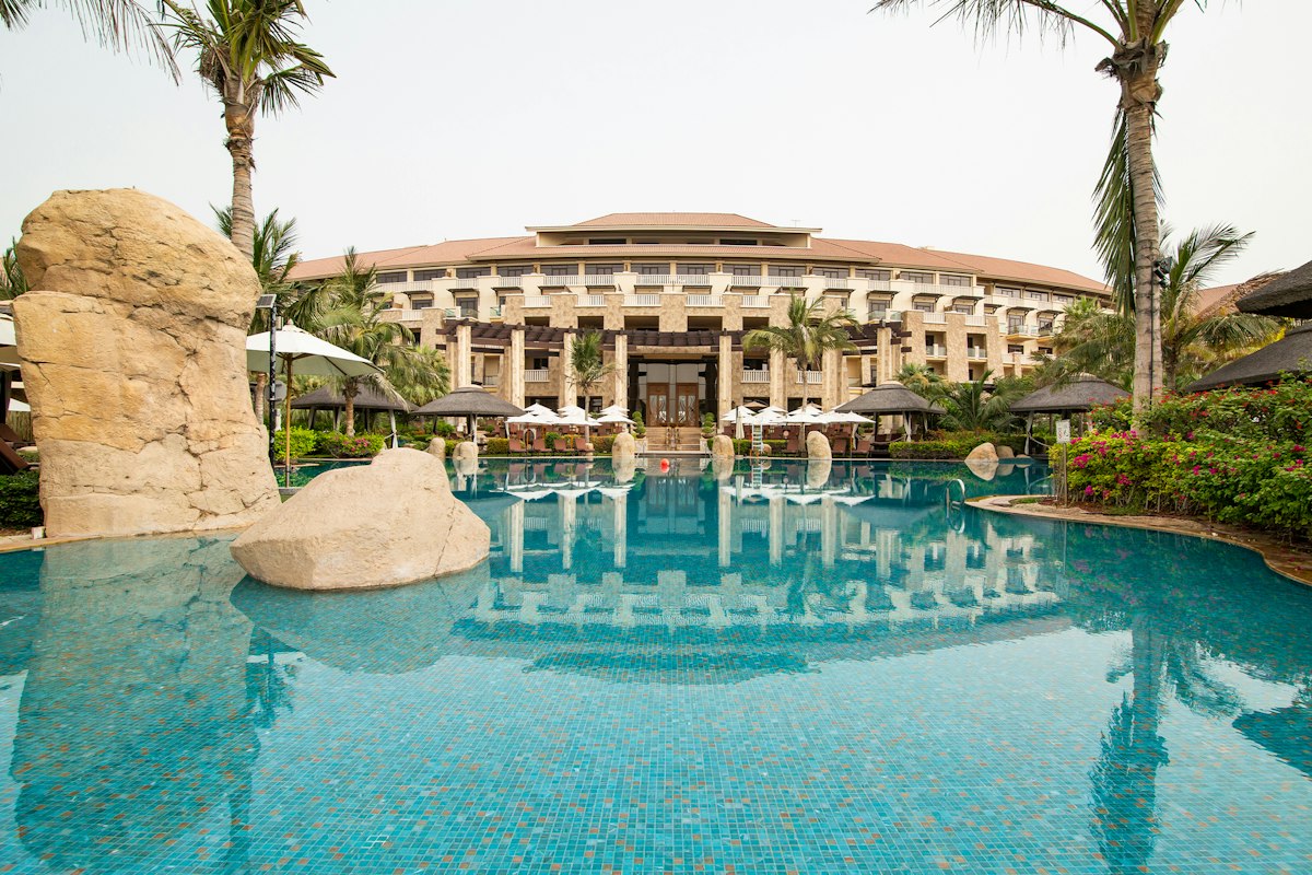 Resort pool with stone features and tropical landscaping