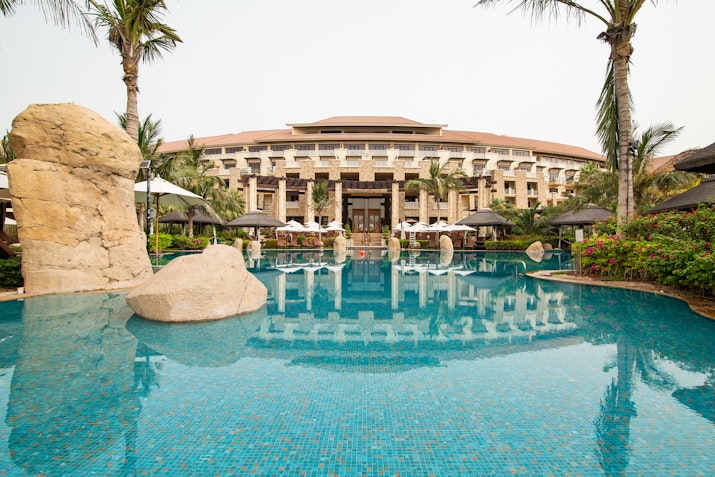 Resort pool with stone features and tropical landscaping