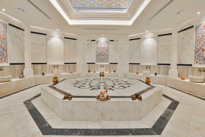 Elegant marble spa room with intricate design and soft lighting
