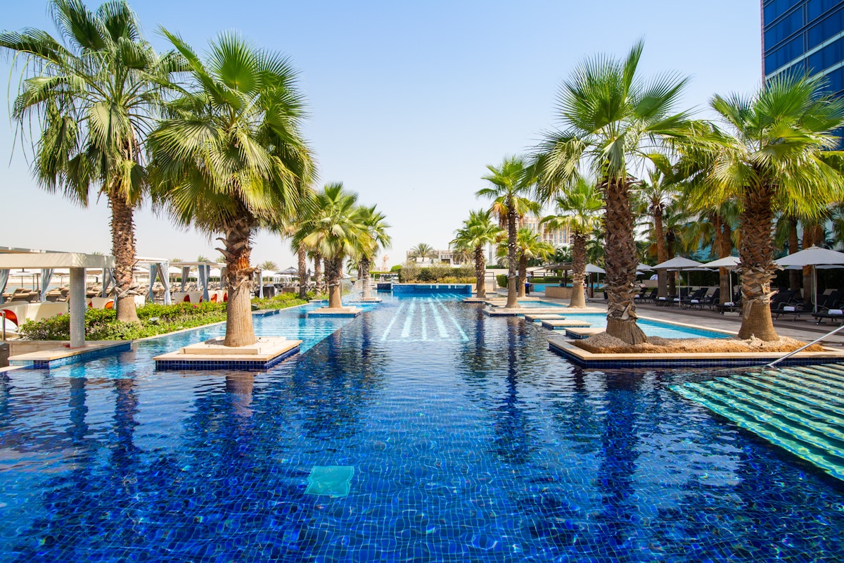Fairmont Bab Al Bahr Palm trees lining a luxurious outdoor swimming pool