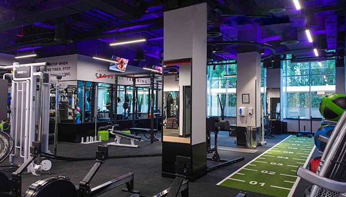 Volt Fitness A modern gym interior featuring various fitness equipment, bright lighting, and a turf area for workouts.
