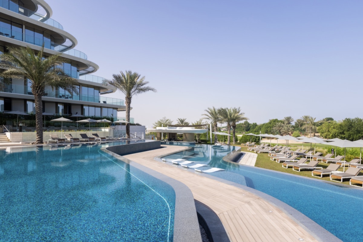 JA Lake Infinity pool with lounge chairs and modern architecture