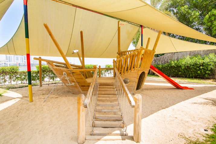 Wooden pirate ship playground with slide.