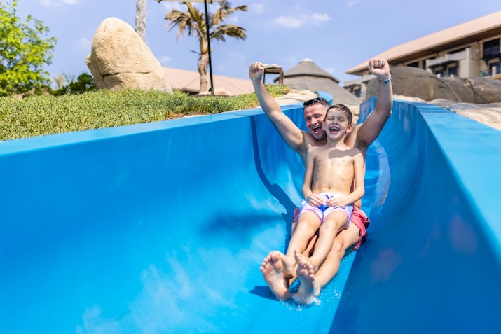 Sofitel The Palm Father and son enjoying a ride on a water slide