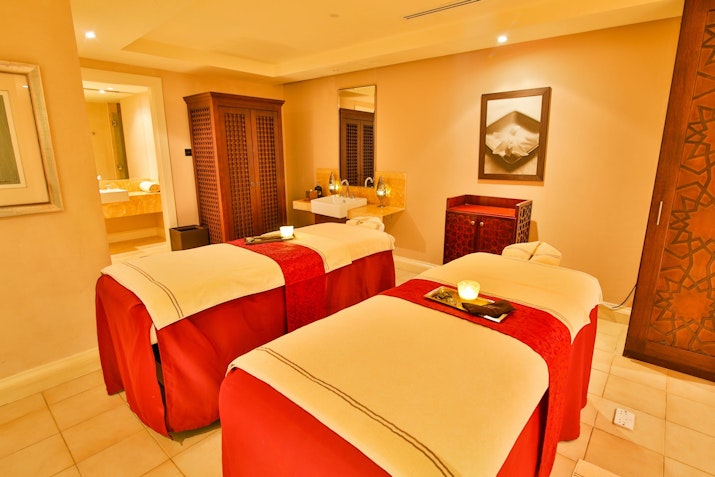 Spa treatment room with two massage beds.
