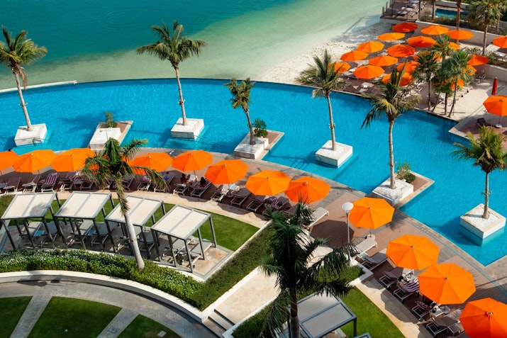 Grand Hyatt Abu Dhabi Inviting pool area surrounded by comfortable lounge chairs and scenic views.