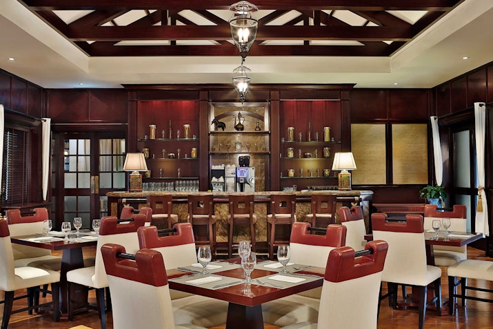 Interior of restaurant featuring warm, inviting atmosphere with elegant decor.