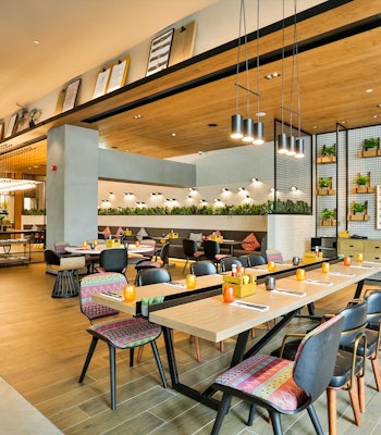 Social Company at Zabeel House The Greens offers a collaborative workspace. Spacious, well-designed communal workspace with wooden and fabric interiors