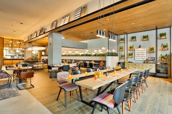 Spacious, well-designed communal workspace with wooden and fabric interiors