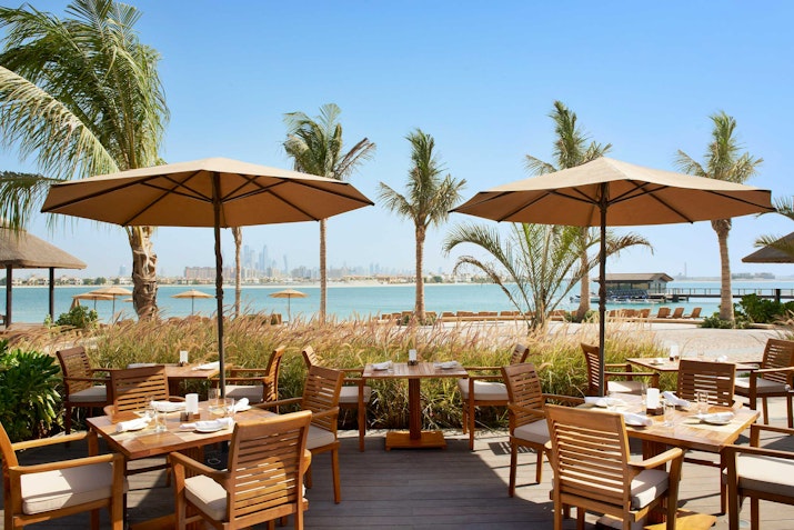 Maui Beach Restaurant at Sofitel the Palm offers scenic views Outdoor seating with beach and city views.