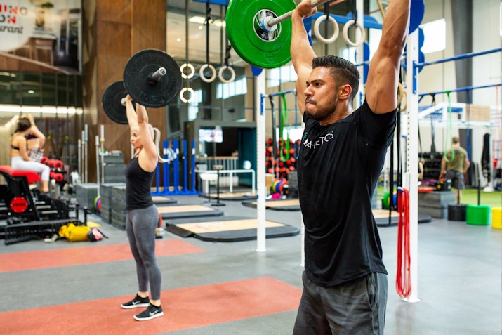 CrossFit area equipped with weightlifting bars, kettlebells, and workout rigs for high-intensity training.