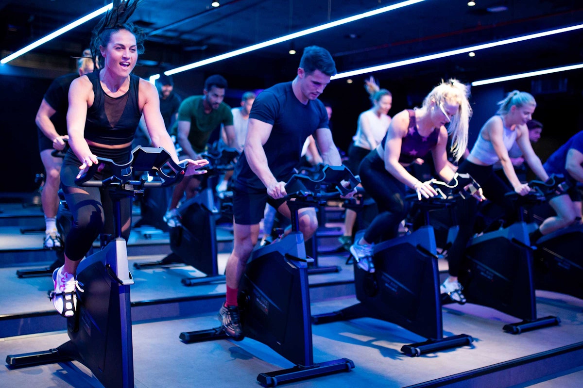 Group of people in an intense indoor cycling class