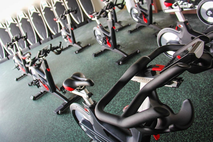 Indoor cycling studio with rows of stationary bikes