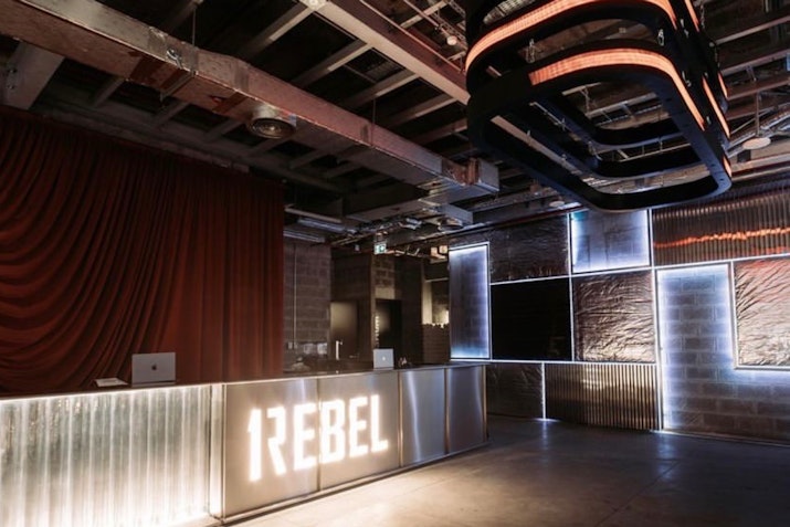 1Rebel Gym reception with illuminated logo and industrial decor