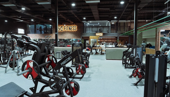 24 Fitness Large fitness facility equipped with weight machines, free weights, and an open layout, providing a versatile workout environment.