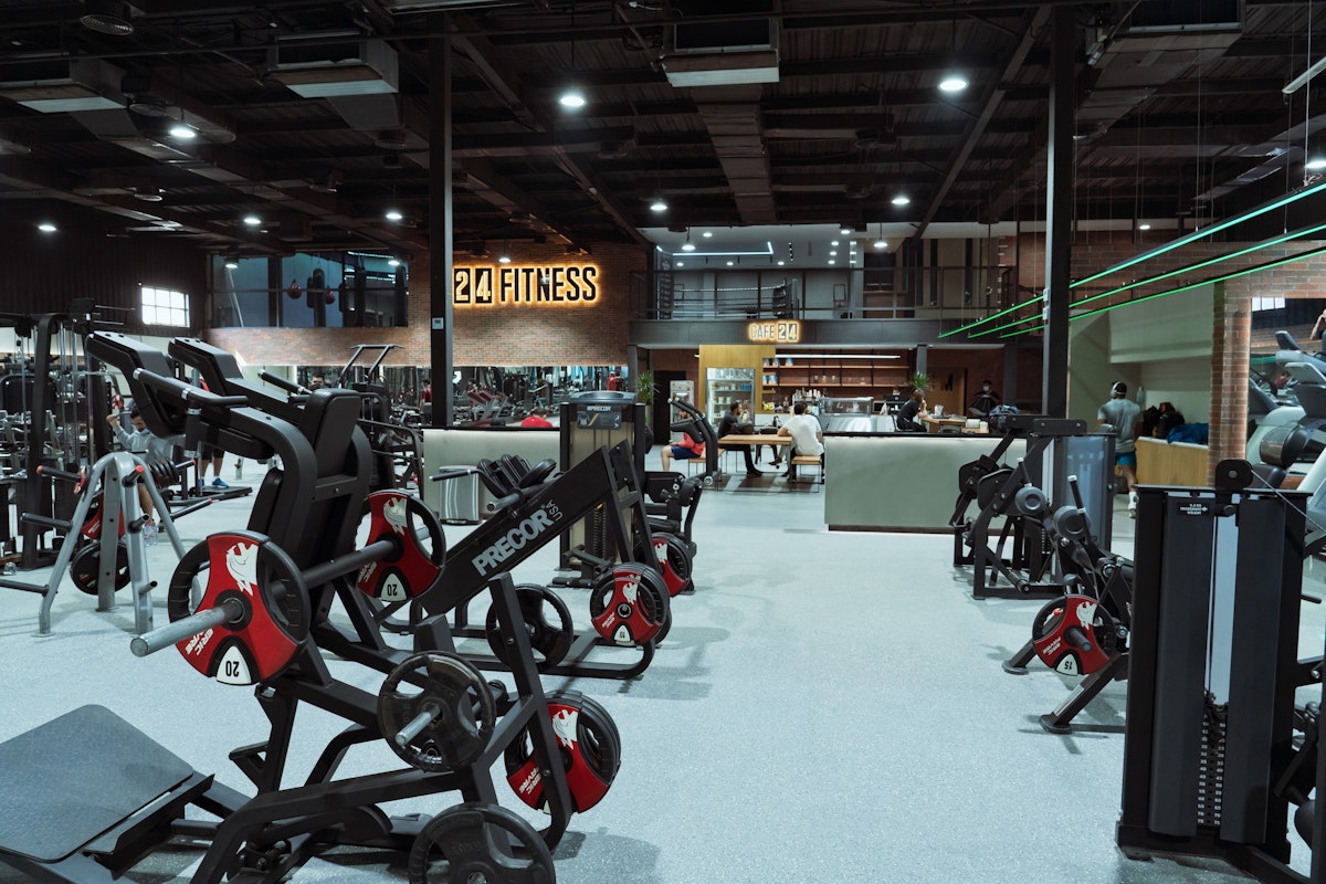24 Fitness Large fitness facility equipped with weight machines, free weights, and an open layout, providing a versatile workout environment.