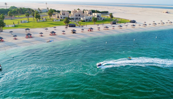 Al Maya Island & Resort Aerial view of beach resort with jet skis in the water