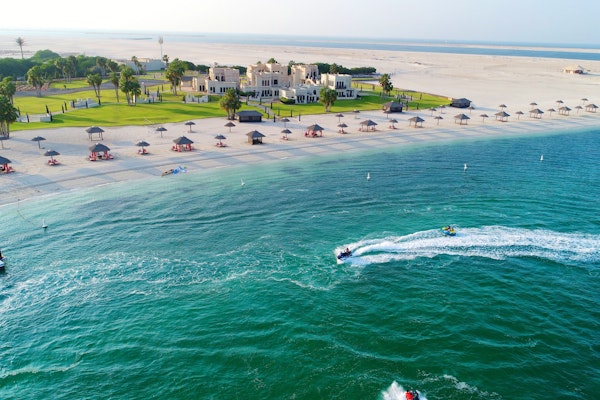 Aerial view of beach resort with jet skis in the water