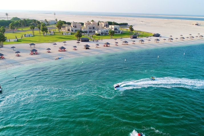 Aerial view of beach resort with jet skis in the water